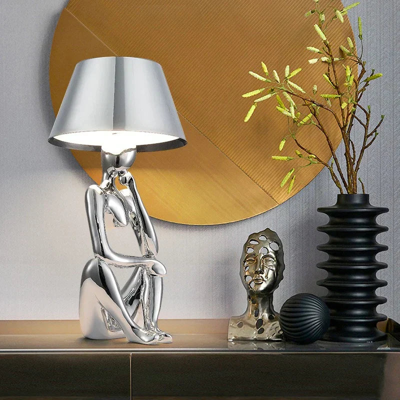 Lampada da tavolo scultorea con base a figura astratta metallica e paralume a tamburo affusolato